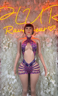 Multicolor halter bodysuit with strappy back and purple-blue patterned shorts