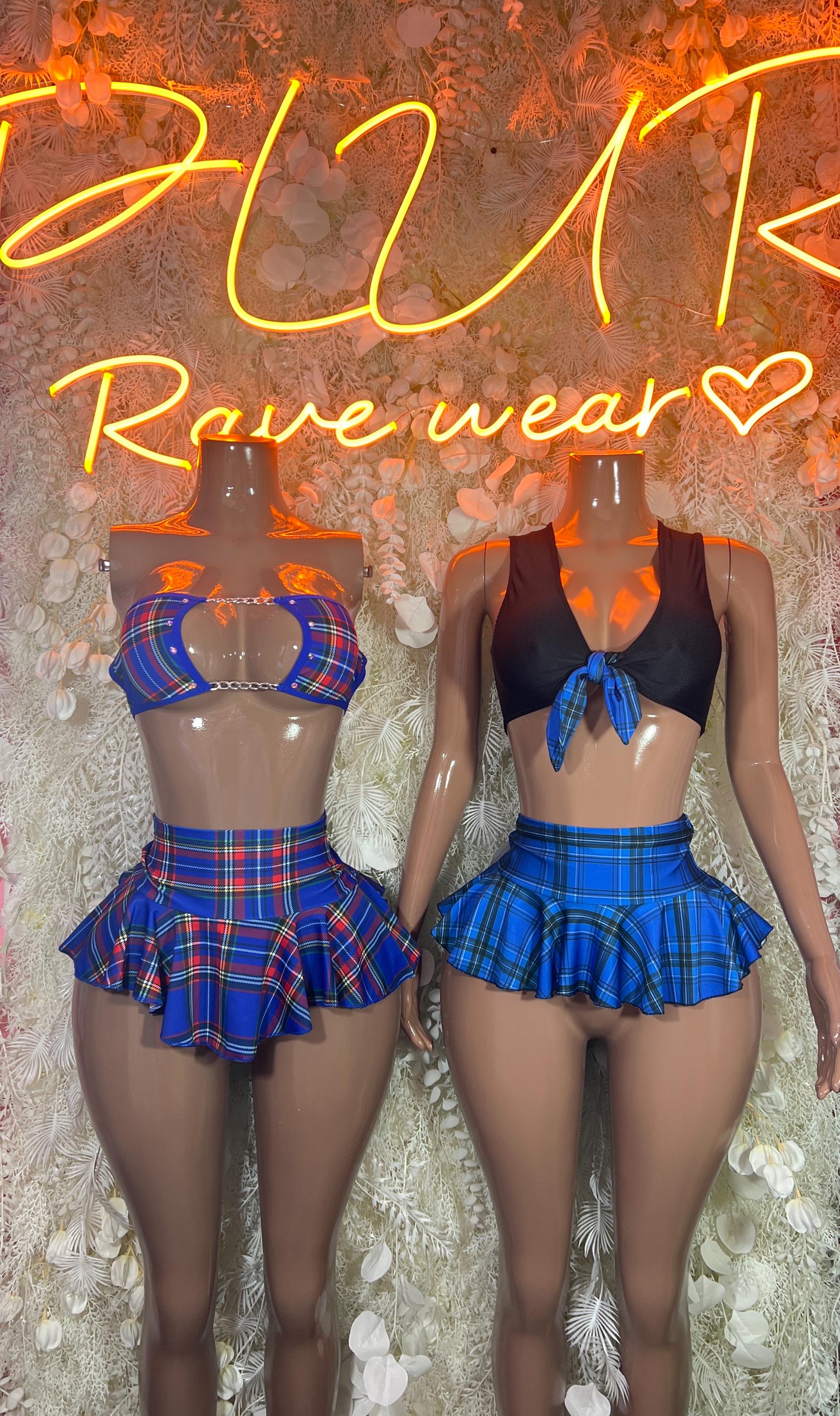 Two-piece rave skirt set on two models: black crop tops and blue plaid ruffle mini skirts