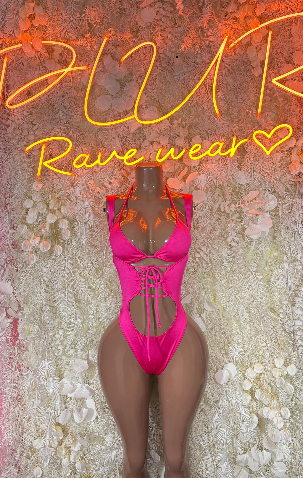 Pink lace-up bodysuit with front cutout and thong bottom