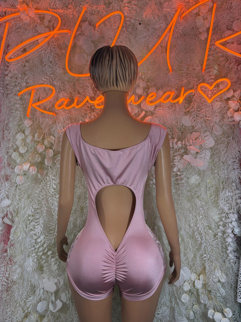 Lilac velvet one-piece bodysuit with open-back keyhole and ruched front, short legs.