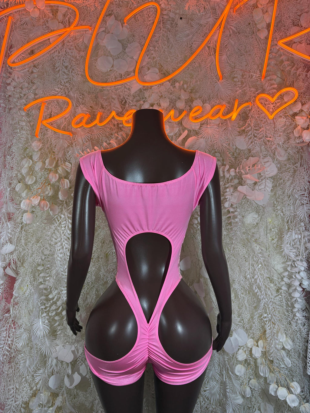 Pink satin bodysuit with open back cutout and ruched lower edges