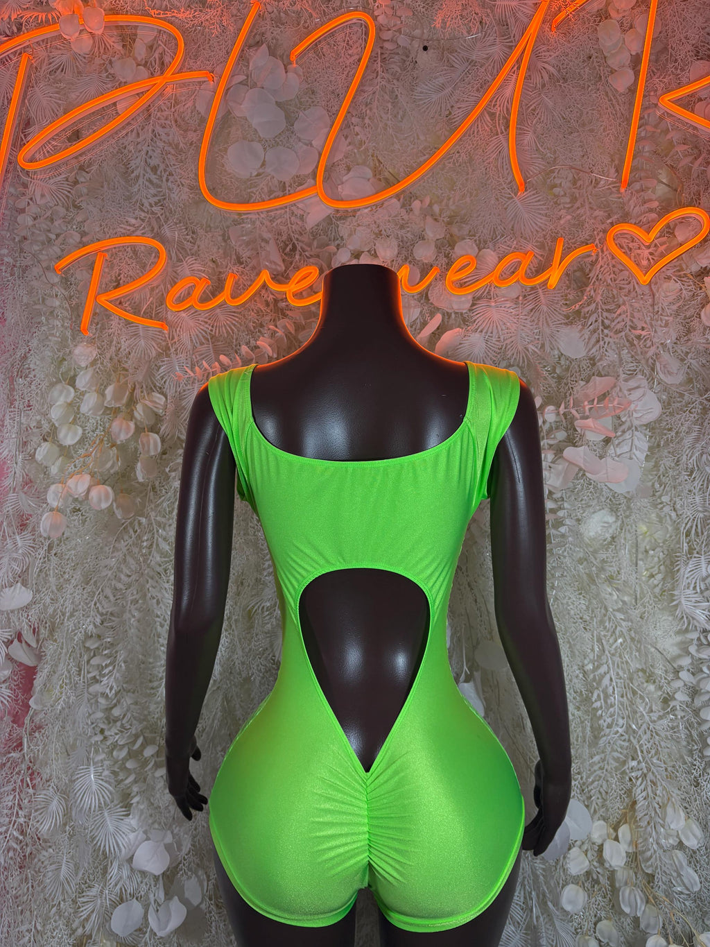 Neon green lace bodysuit with open back oval and high-cut thong-style bottom