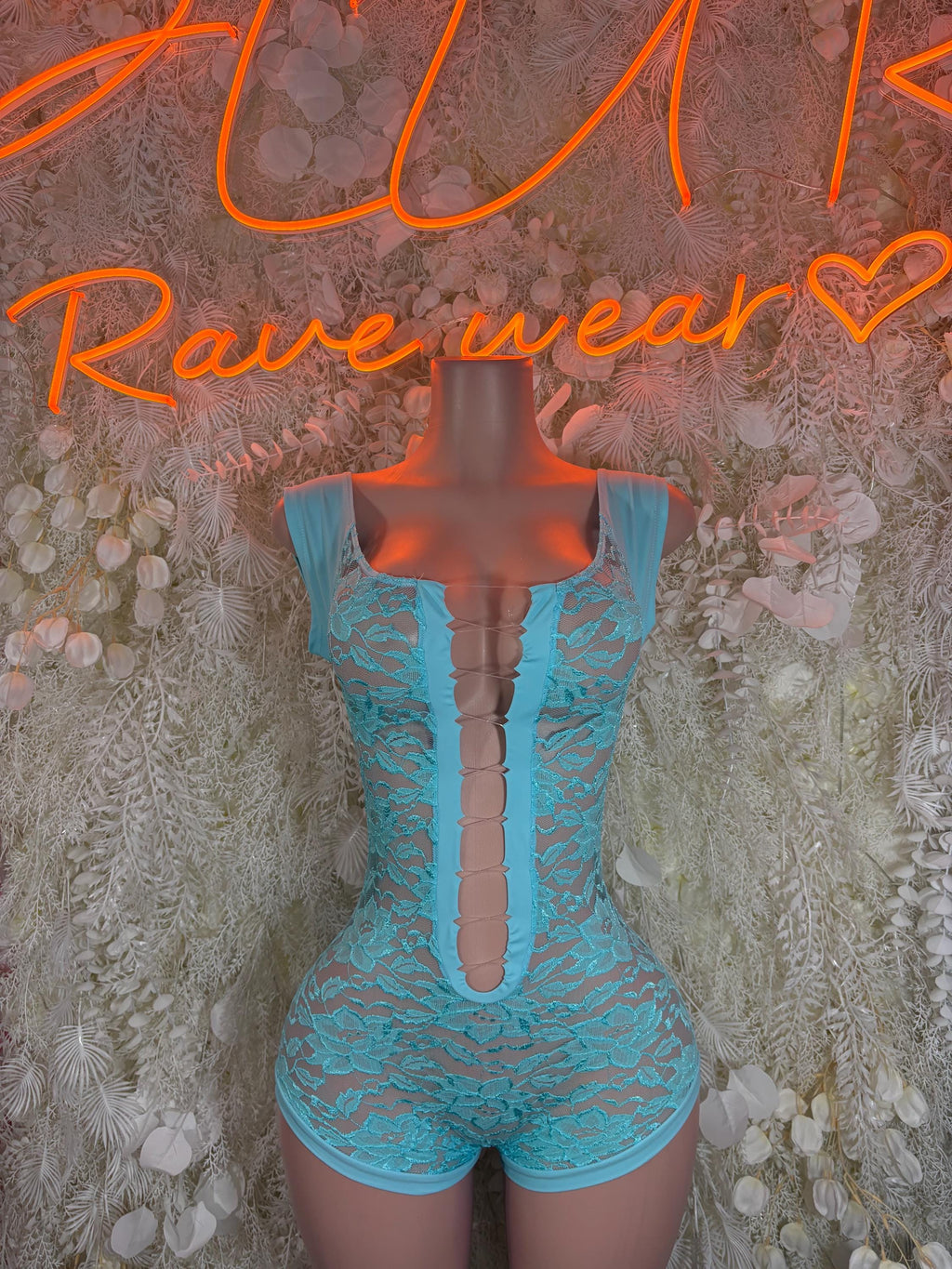 Turquoise lace bodysuit with sleeveless cut, deep front V, and high-cut shorts