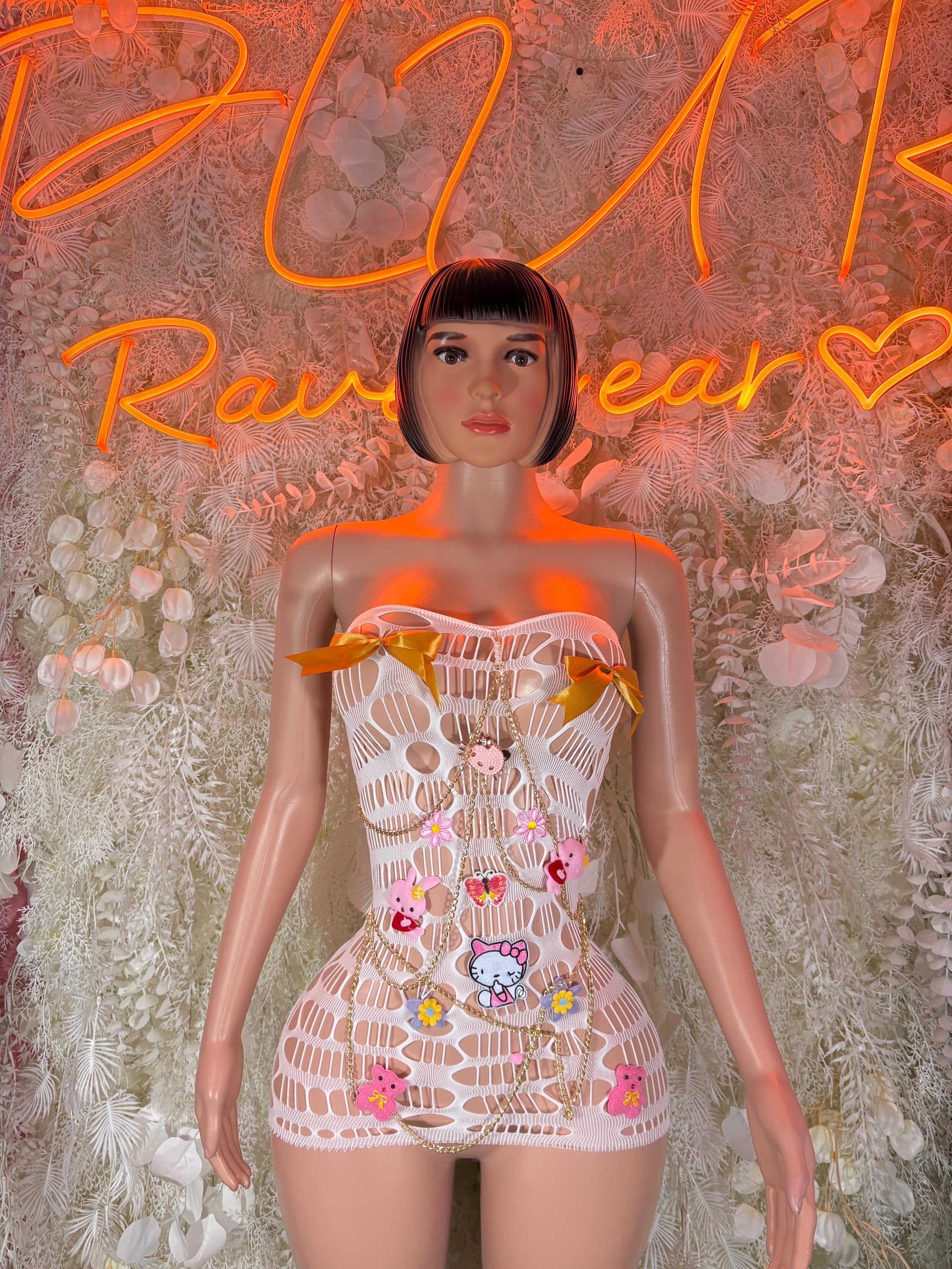 White fishnet mini dress with bandeau neckline and colorful graphic patch details