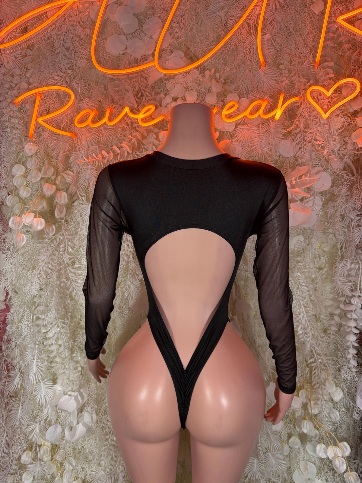 Black open-back bodysuit with crisscross lacing and long sheer sleeves