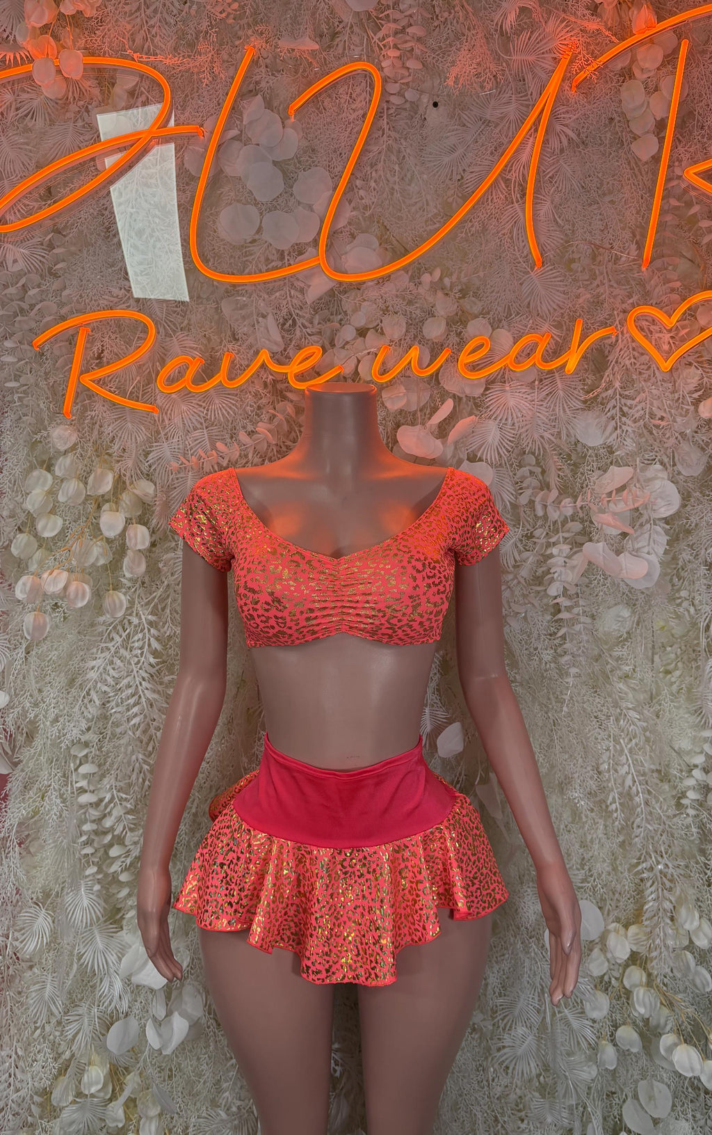 Coral cheetah-print rave set with off-shoulder crop top and flared mini skirt