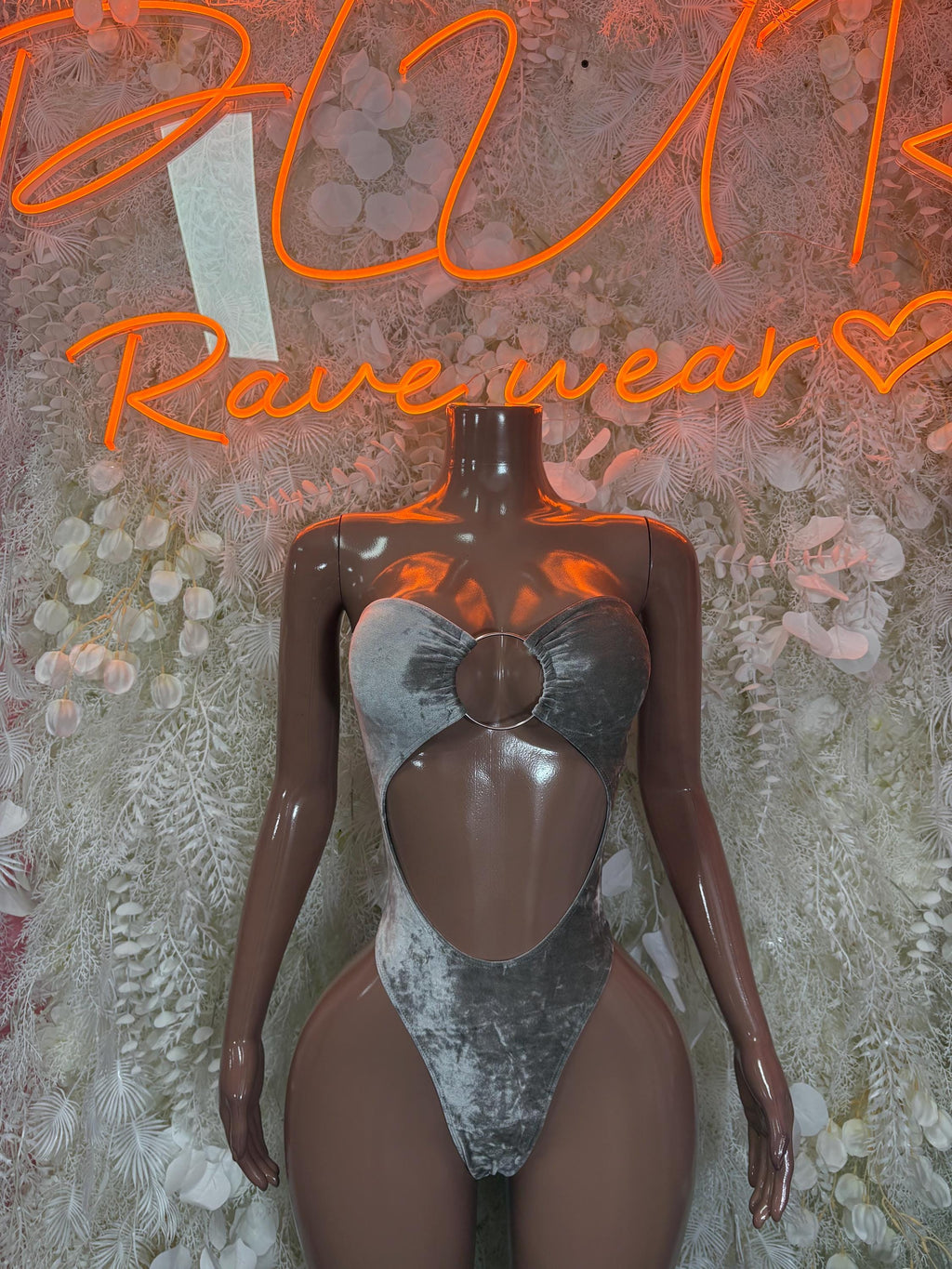 Silver velvet bodysuit with halter neckline and central cutout, high-cut leg