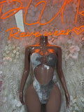 Silver velvet bodysuit with halter neckline and central cutout, high-cut leg