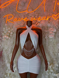 White halter mini dress with draped bodice and layered chain detail