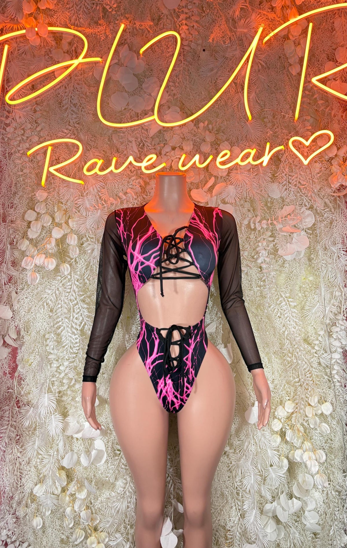 Pink and purple lightning lace-up bodysuit with long sheer sleeves, festival romper