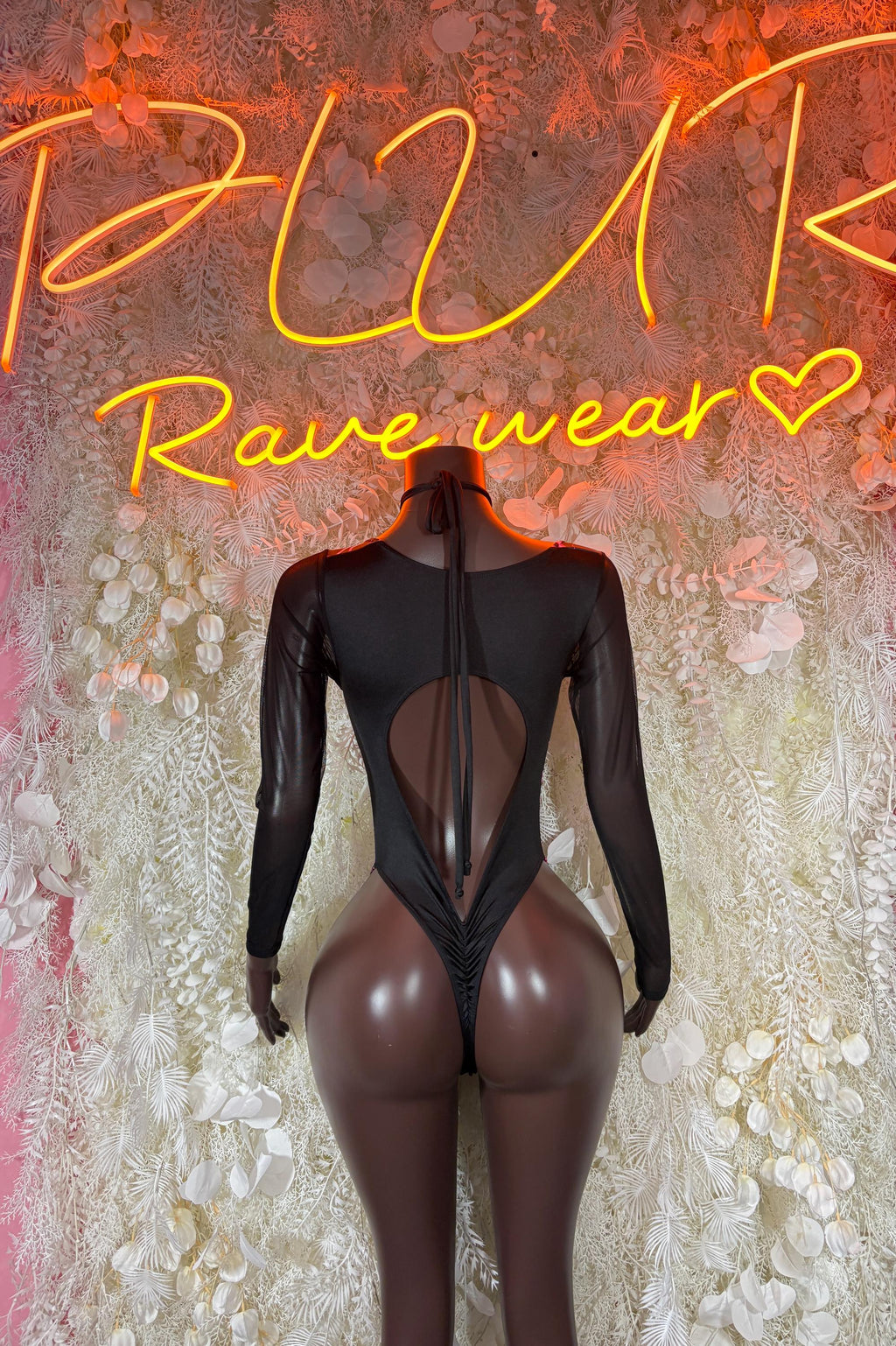 Black sheer long-sleeve bodysuit with open back and neon pink lightning trim, high leg