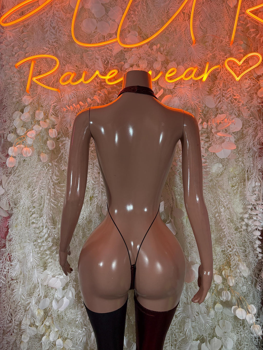 Black lace-up back bodysuit with garter straps and thigh-high stockings
