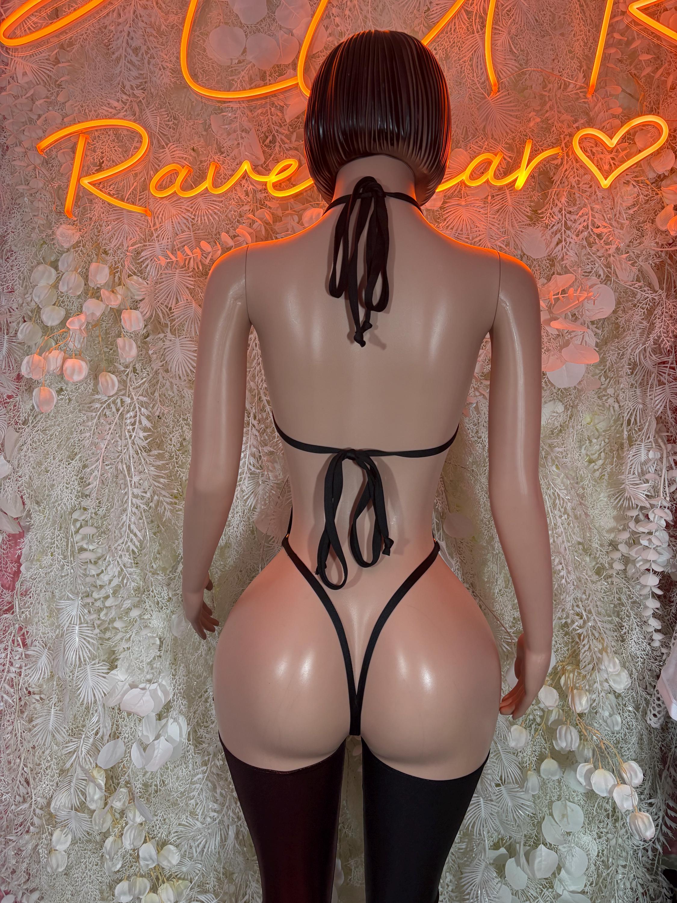 Back view dark red and black lace-up bodysuit with crisscross straps and leggings