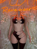 Black strappy lingerie set with cutout bra, high-leg bottoms, and thigh-high stockings