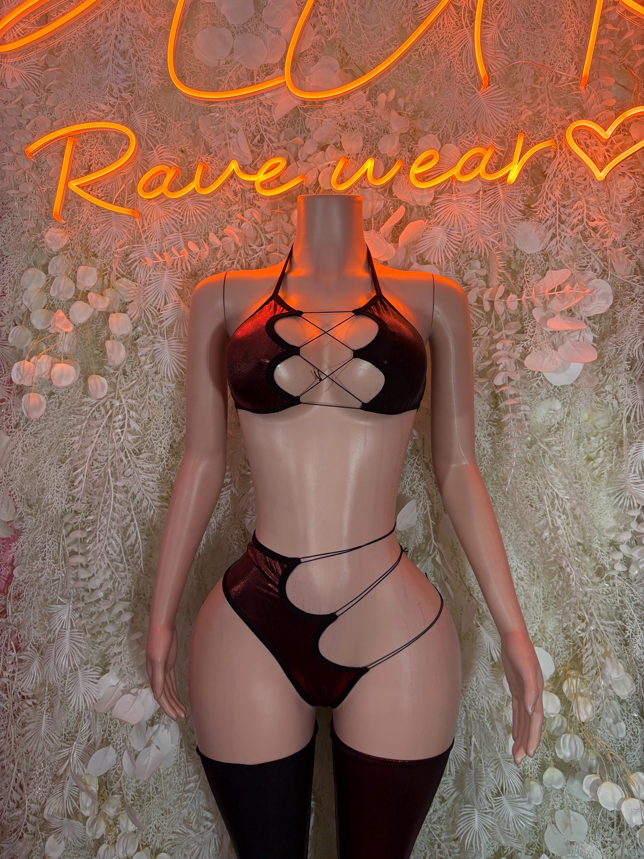 Black strappy lingerie set with cutout bra, high-leg bottoms, and thigh-high stockings