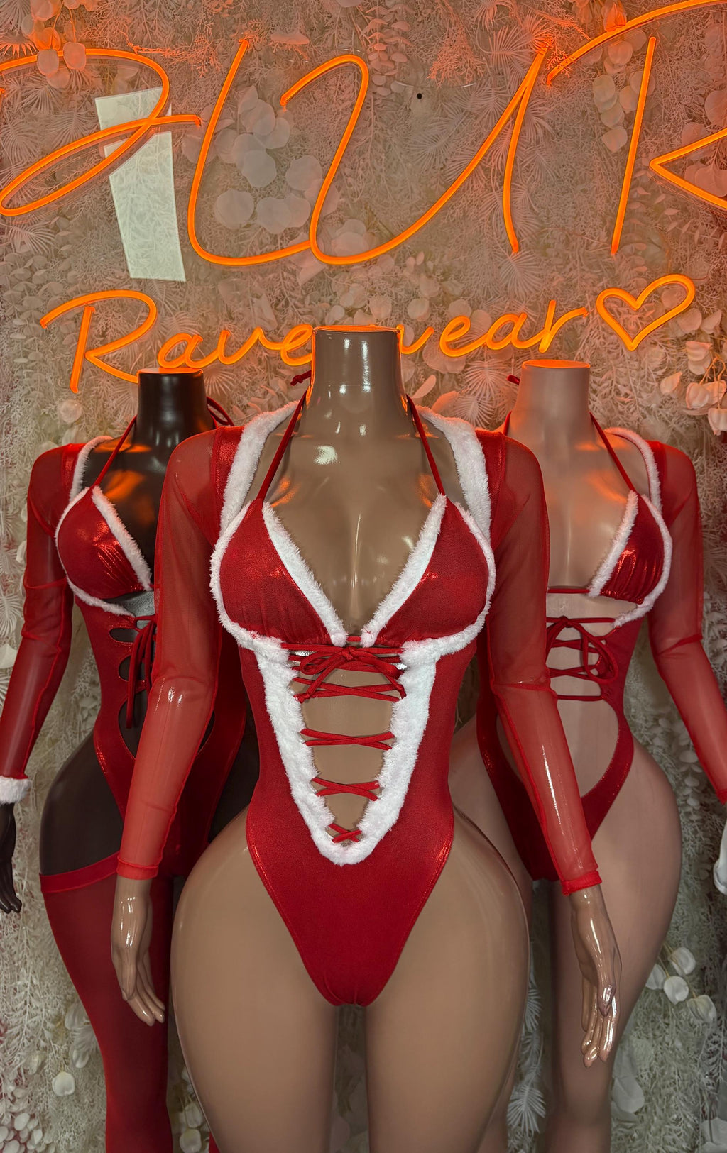 Red Santa-style bodysuit with deep V neckline, white trim, and crisscross lace front