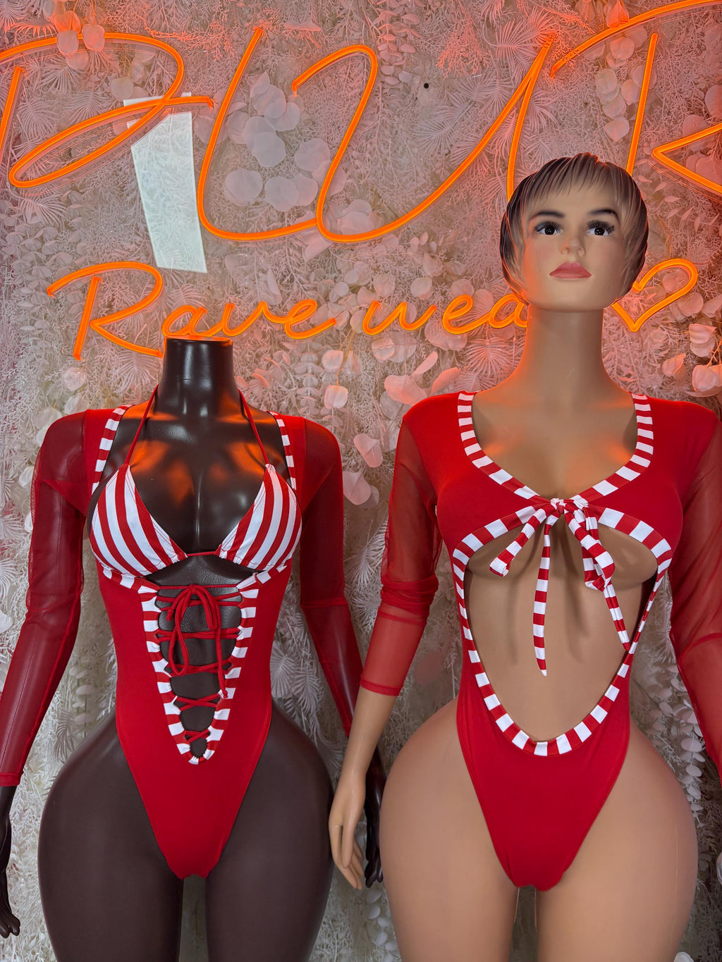 Red Santa-style bodysuits with white striped trim and cutout lace-up