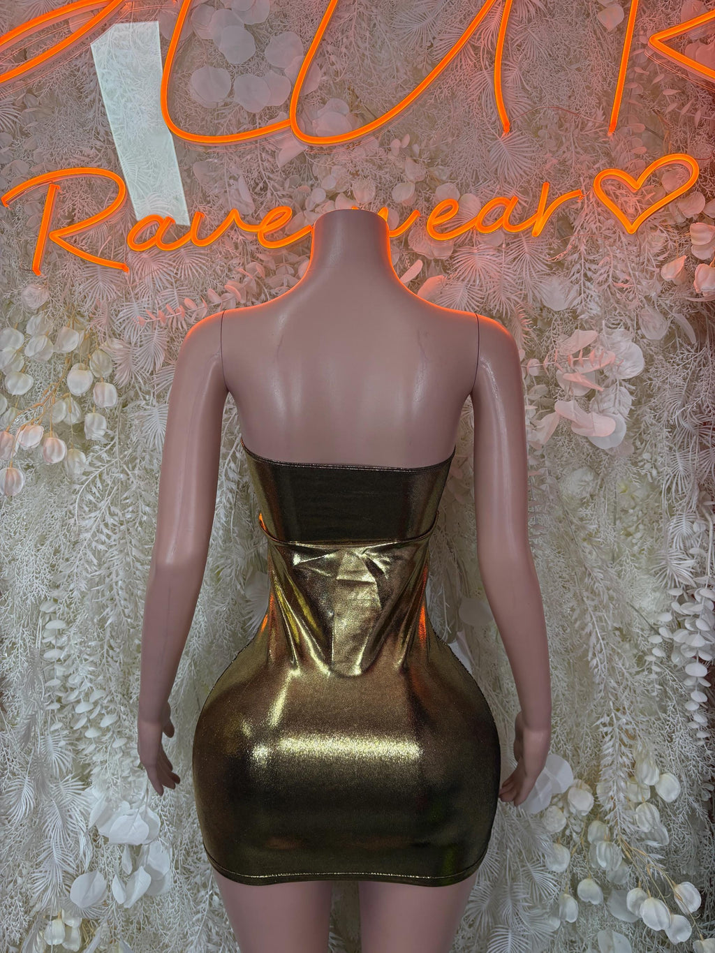Back of gold metallic club dress with black corset bodice and gold drape