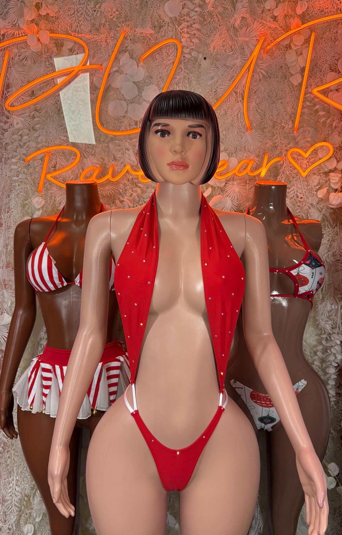 Red Santa-style halter lingerie with plunging bikini top and striped bottoms on mannequin