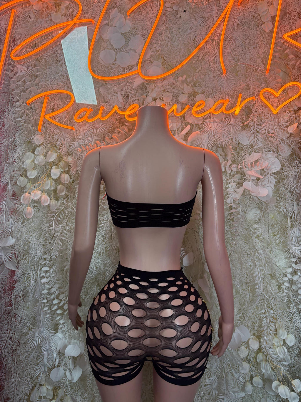 Two-piece dancewear set with black bandeau top and high-waist shorts with polka-dot cutouts