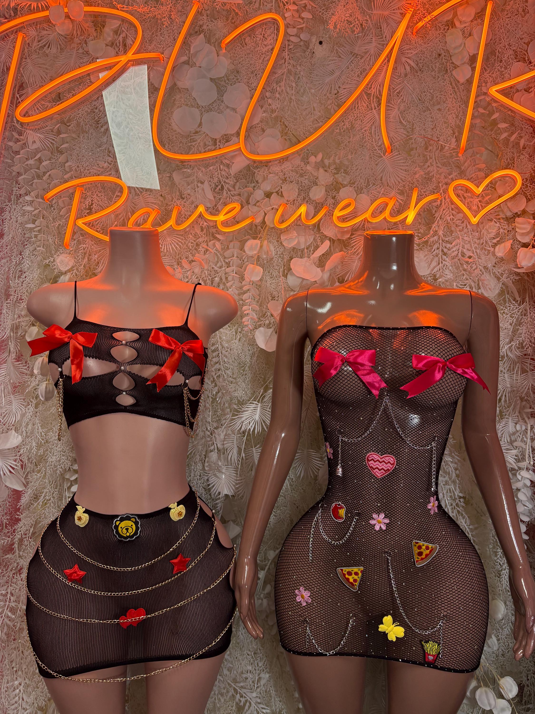 Black mesh two-piece dancewear set with heart bow accents and pin-style appliqués