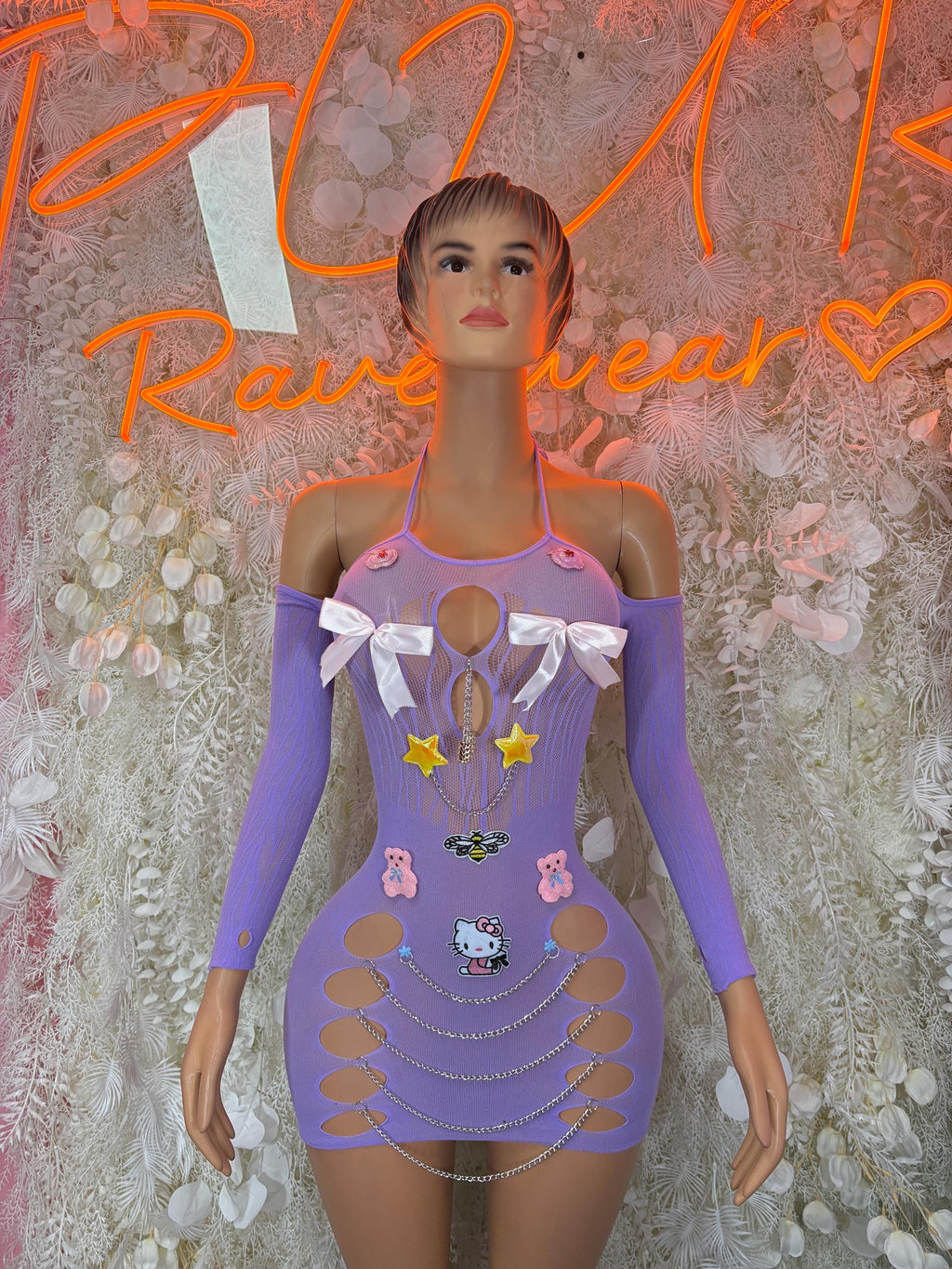 Purple mini dress with bow accents, graphic panels, and long sheer sleeves