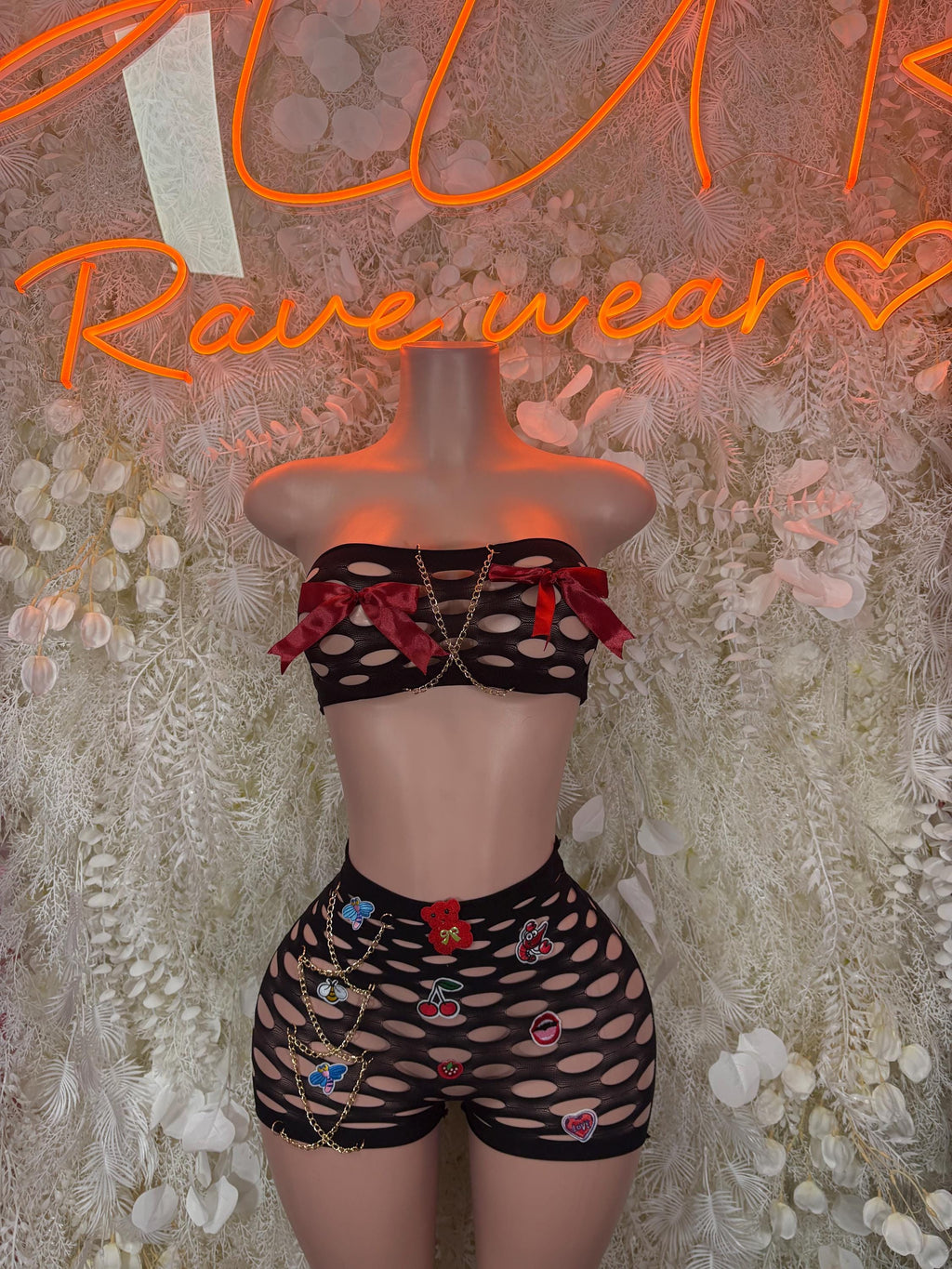 Black fishnet two-piece pinned set: cropped top and high-waist shorts, heart pin detail