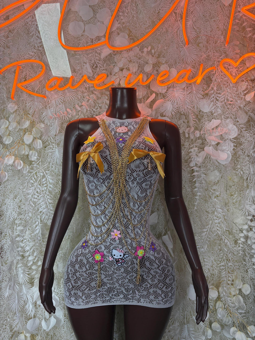 Blue-gray fishnet dress with yellow bows and multicolor pinned details