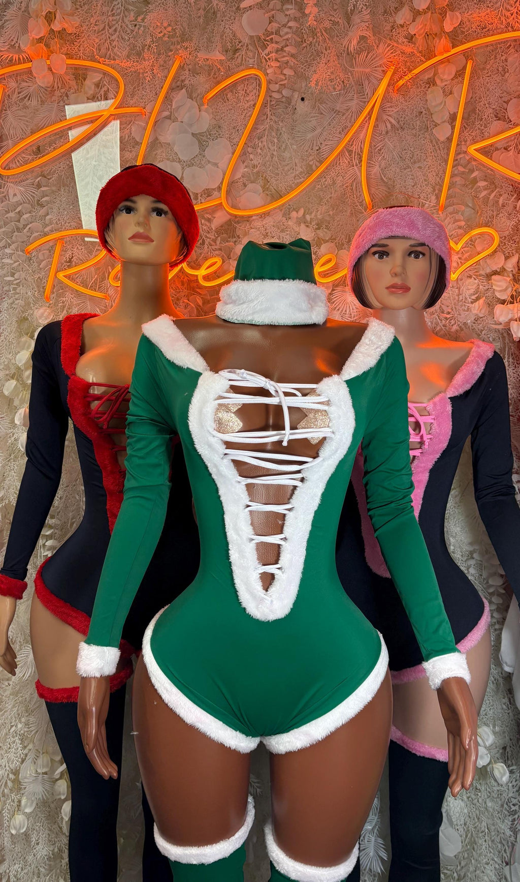 Pink elf bodysuit with white lace-up front, long sleeves, and matching hat