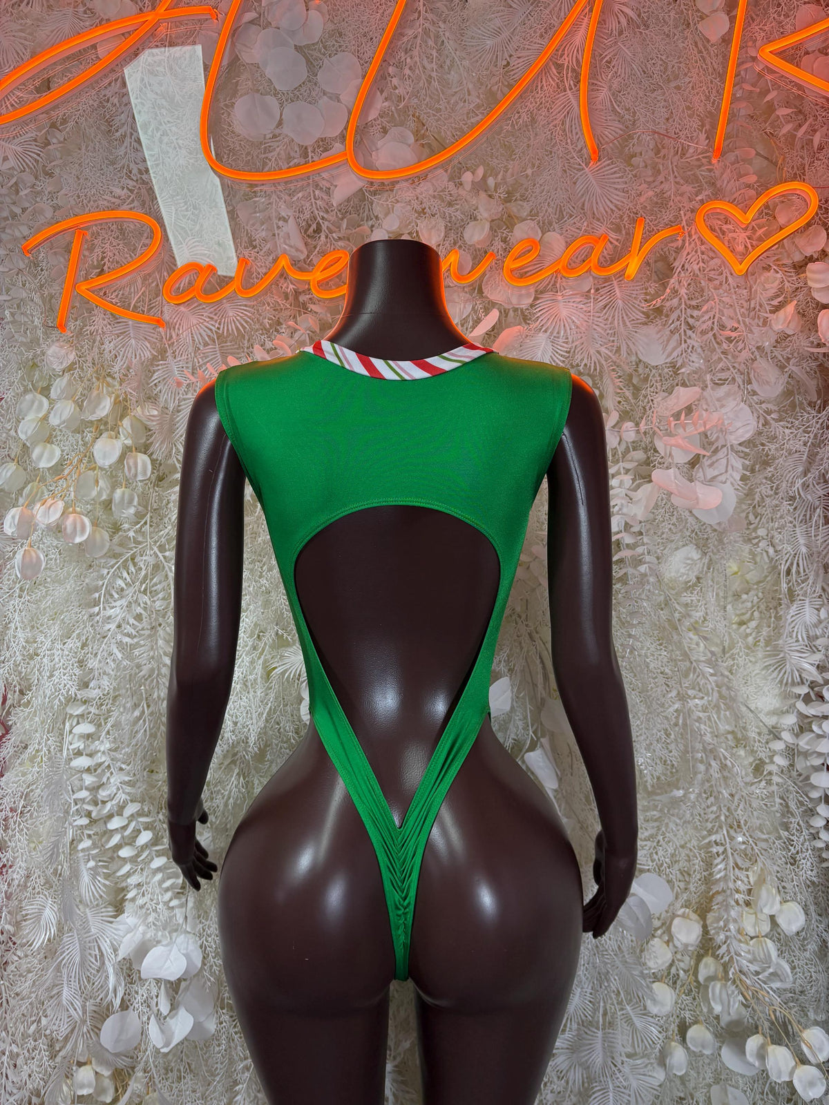 Back view green thong bodysuit with striped strap detailing and open back