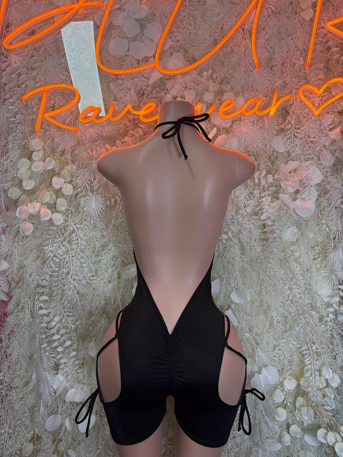 Black metallic one-piece bodysuit, deep V neckline with side lace-up leg cutouts