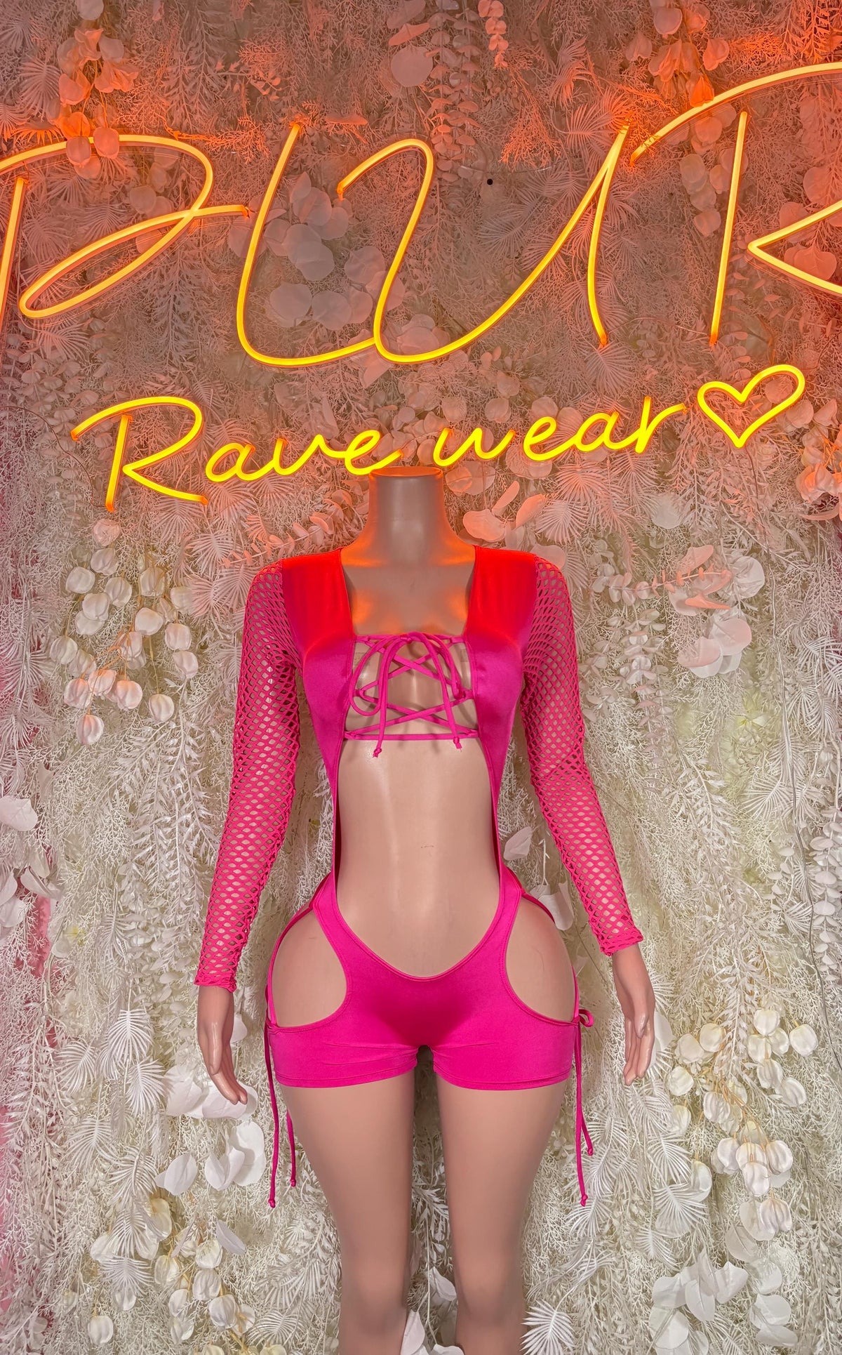 Pink rave bodysuit with long mesh sleeves, open midriff cutout, lace-up front straps