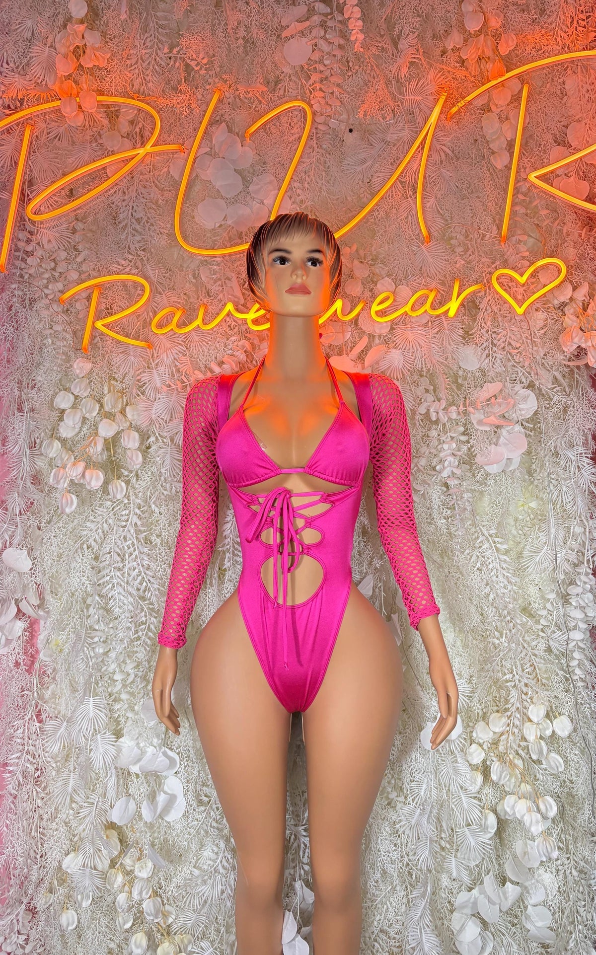 Pink long-sleeve lace-up mesh bodysuit with deep V neckline and cheeky cut