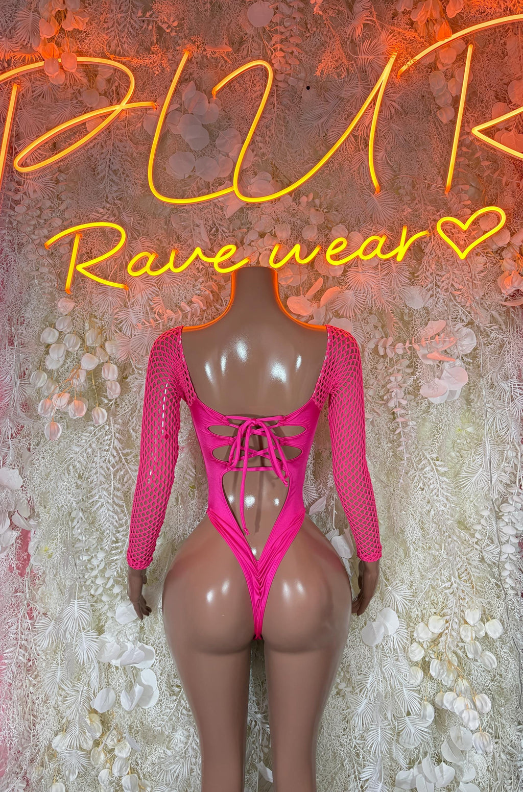 Pink lace-up bodysuit with long mesh sleeves and low back, thong fit