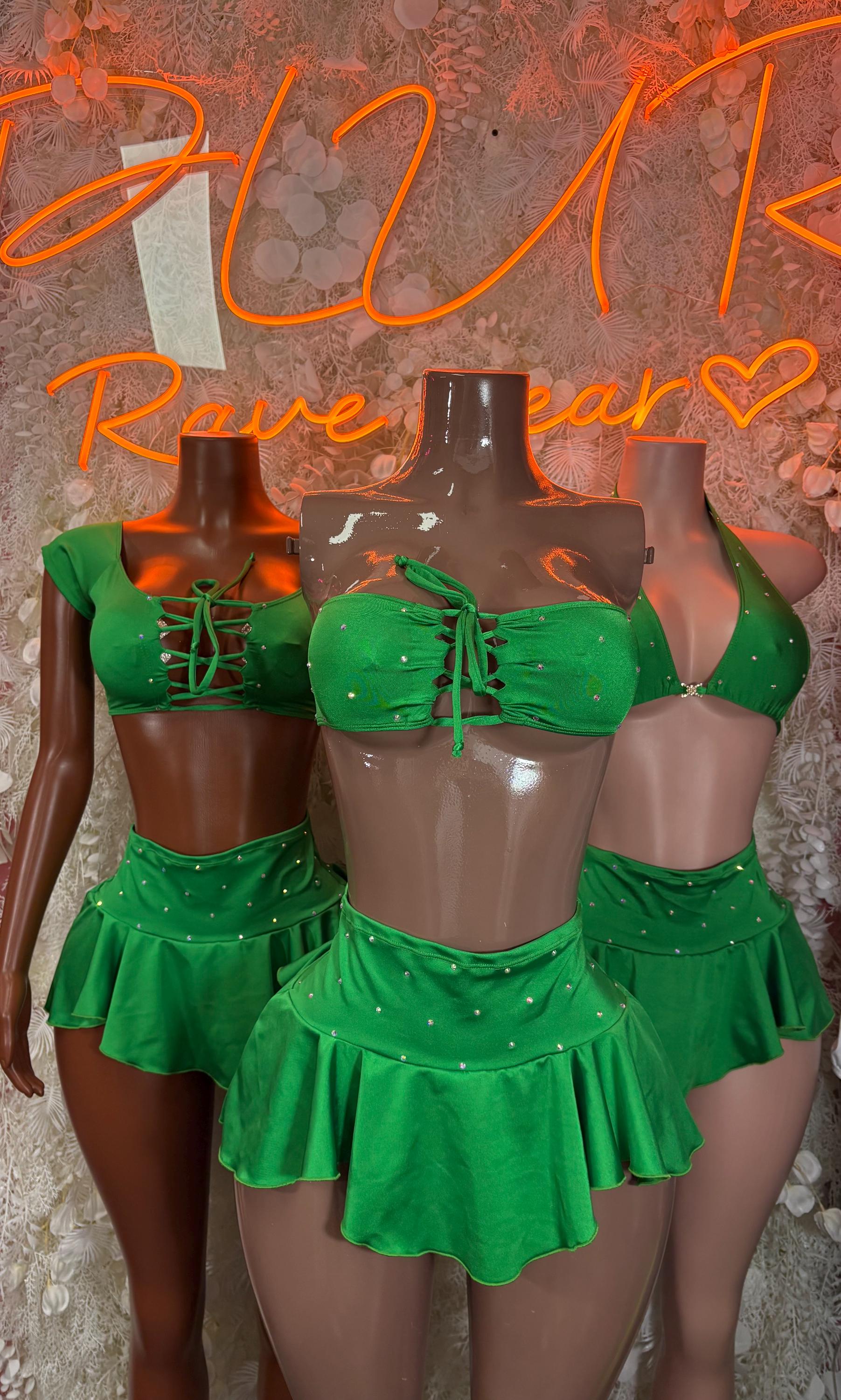 Green two-piece skirt set on mannequins, cropped lace-up tops and flared mini skirts
