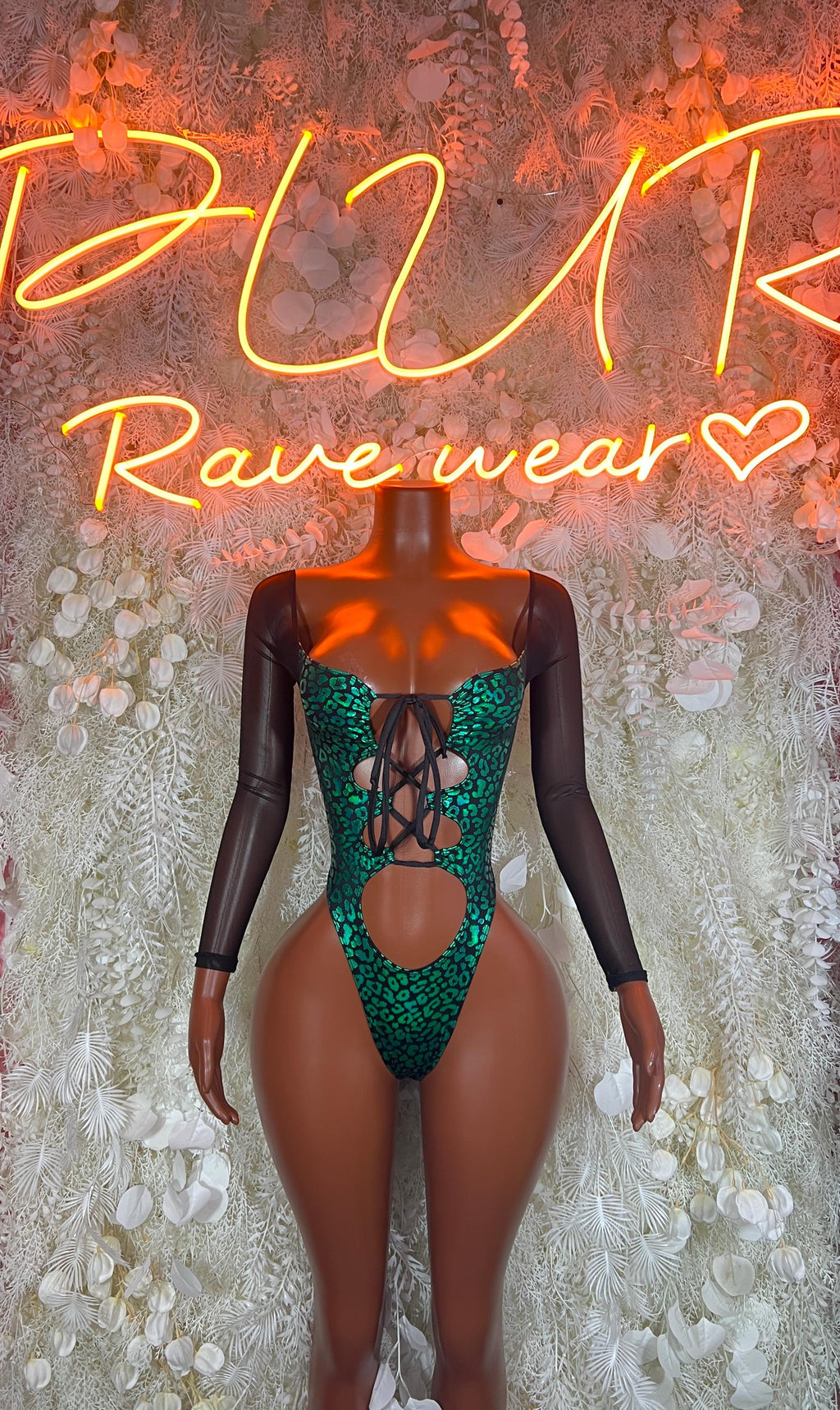 Green cheetah print bodysuit with black long sleeves and crisscross lace-up front