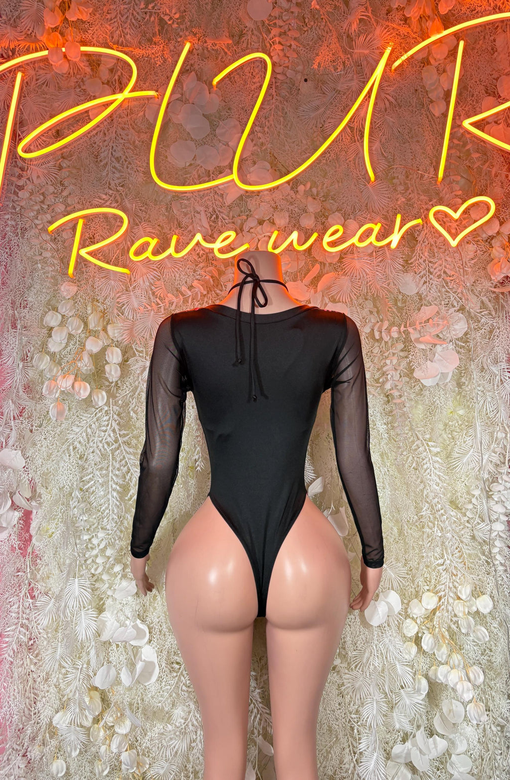 Black long-sleeve bodysuit with neon pink lightning and lace-up open back