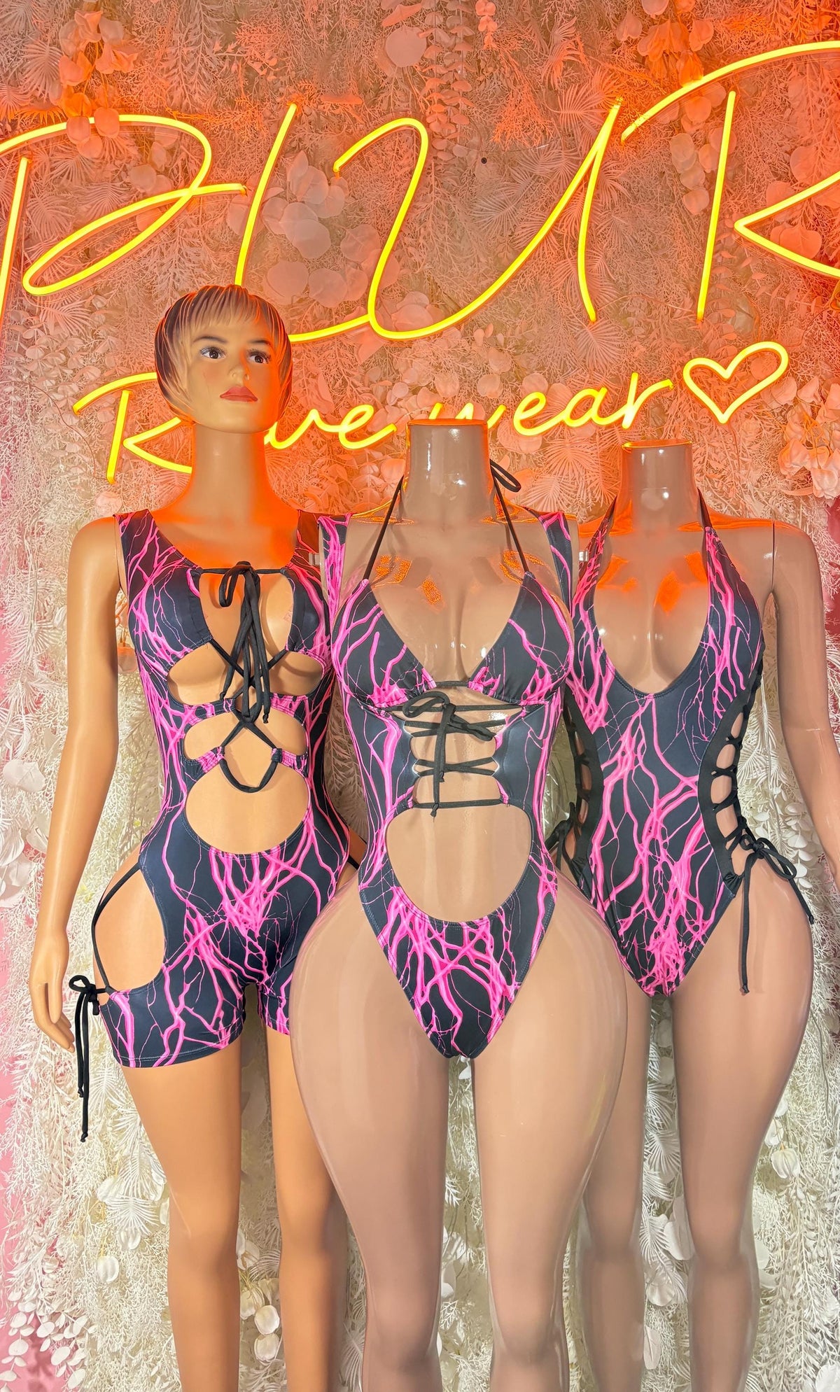 Bottlegirl lightning bolt bodysuit romper in black with pink and purple cutout lace-up