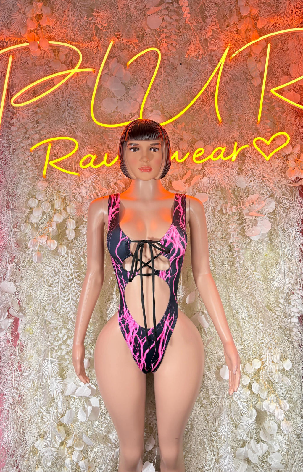 Pink and black lightning-bolt bodysuit with front cutout and thin straps