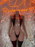 Black strappy rave bodysuit with cutout panels and thigh-high stockings