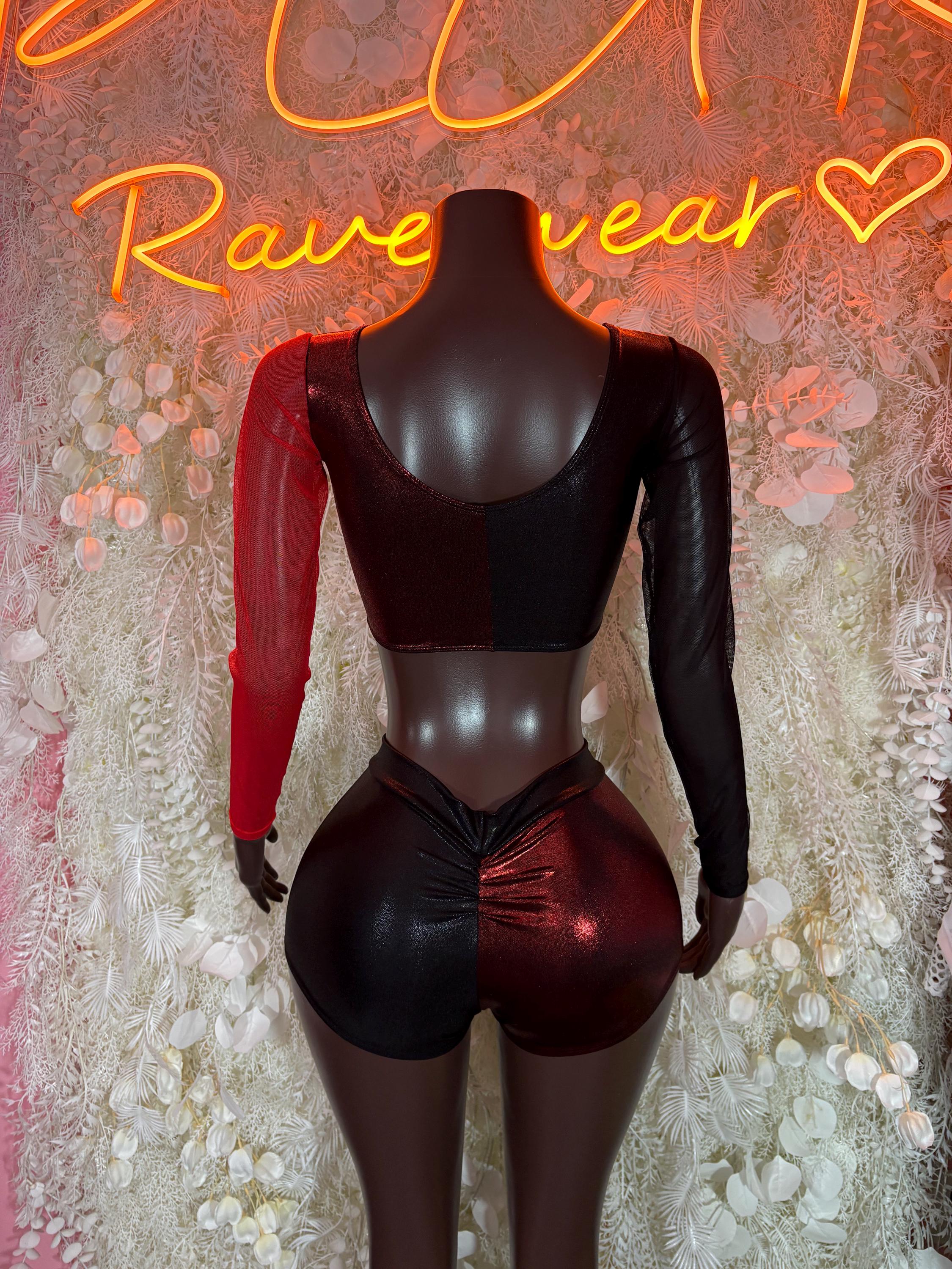 Two-piece rave outfit on mannequin: black bralette crop top with long red sleeves, shorts