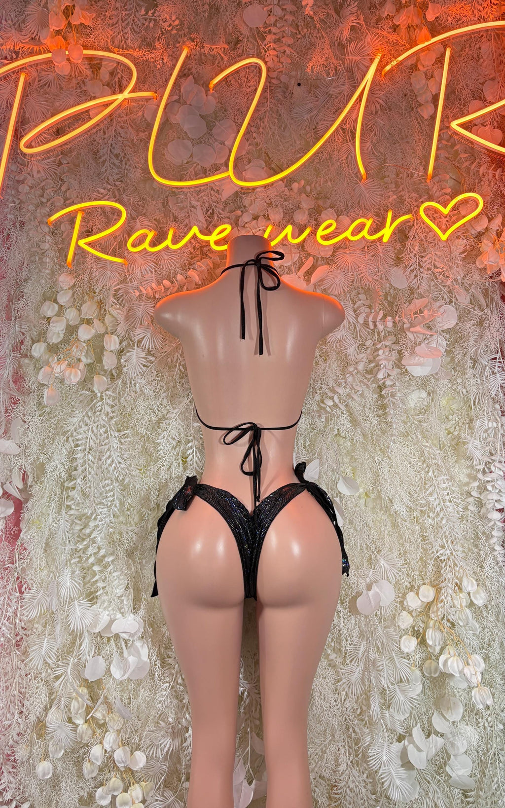 Black two-piece bikini with halter back ties and lace-trim detailing