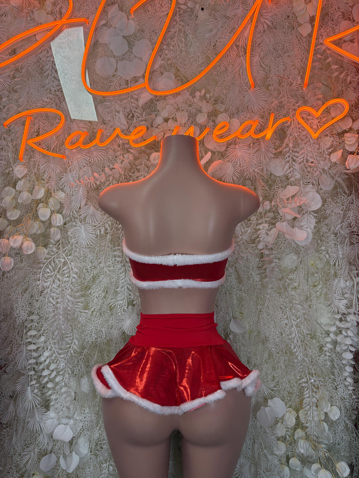 Back view red Santa skirt set with strapless crop top and white faux-fur edging
