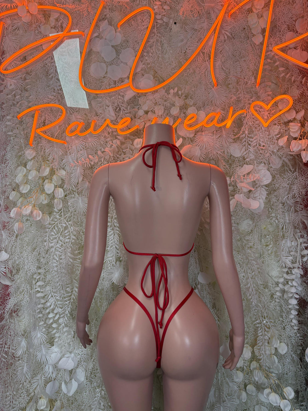Red triangle bikini costume with crisscross tie-back and high-cut bottom