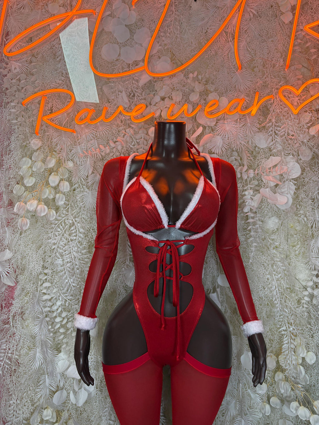 Red Santa-style bodysuit with long sleeves, white trim, and lace-up front