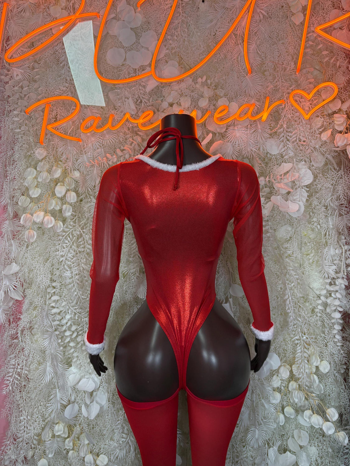 Back view of red Santa-style bodysuit with white cuffs and high-leg cut