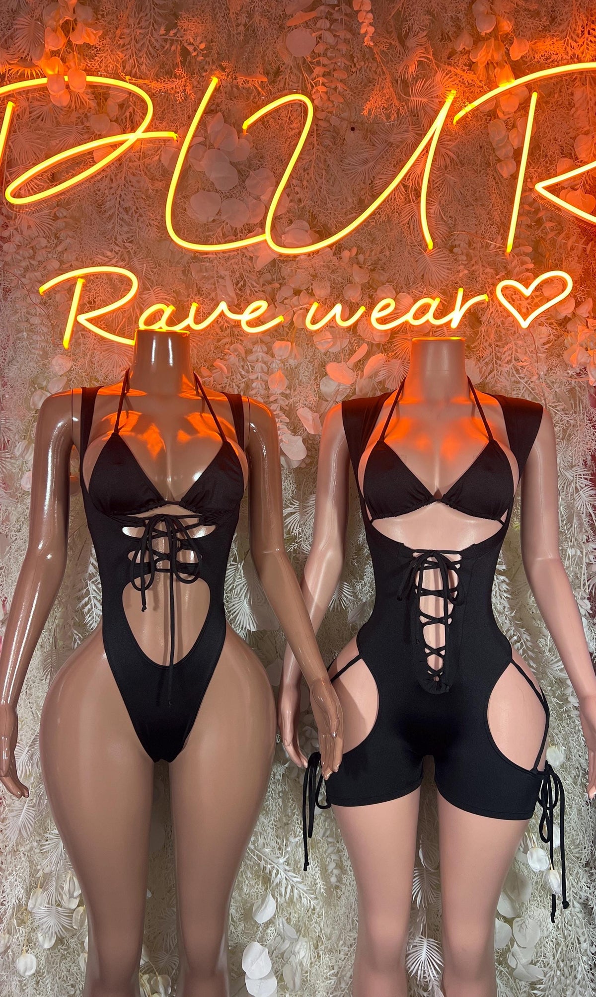 Black lace-up one-piece bodysuit shown from front and back with cutouts