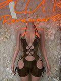 Gold metallic bodysuit with halter neckline, lace-up straps, and circular cutouts