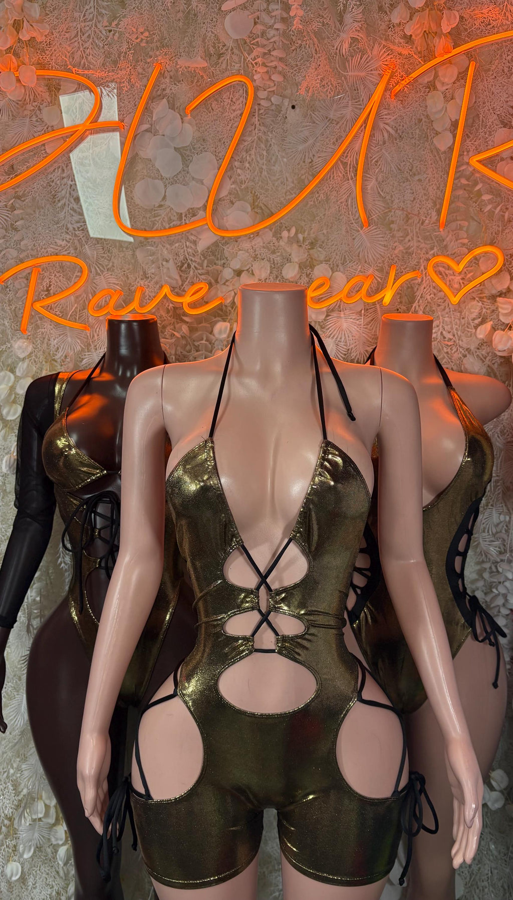 Gold metallic halter bodysuit with lace-up front and large circular cutouts