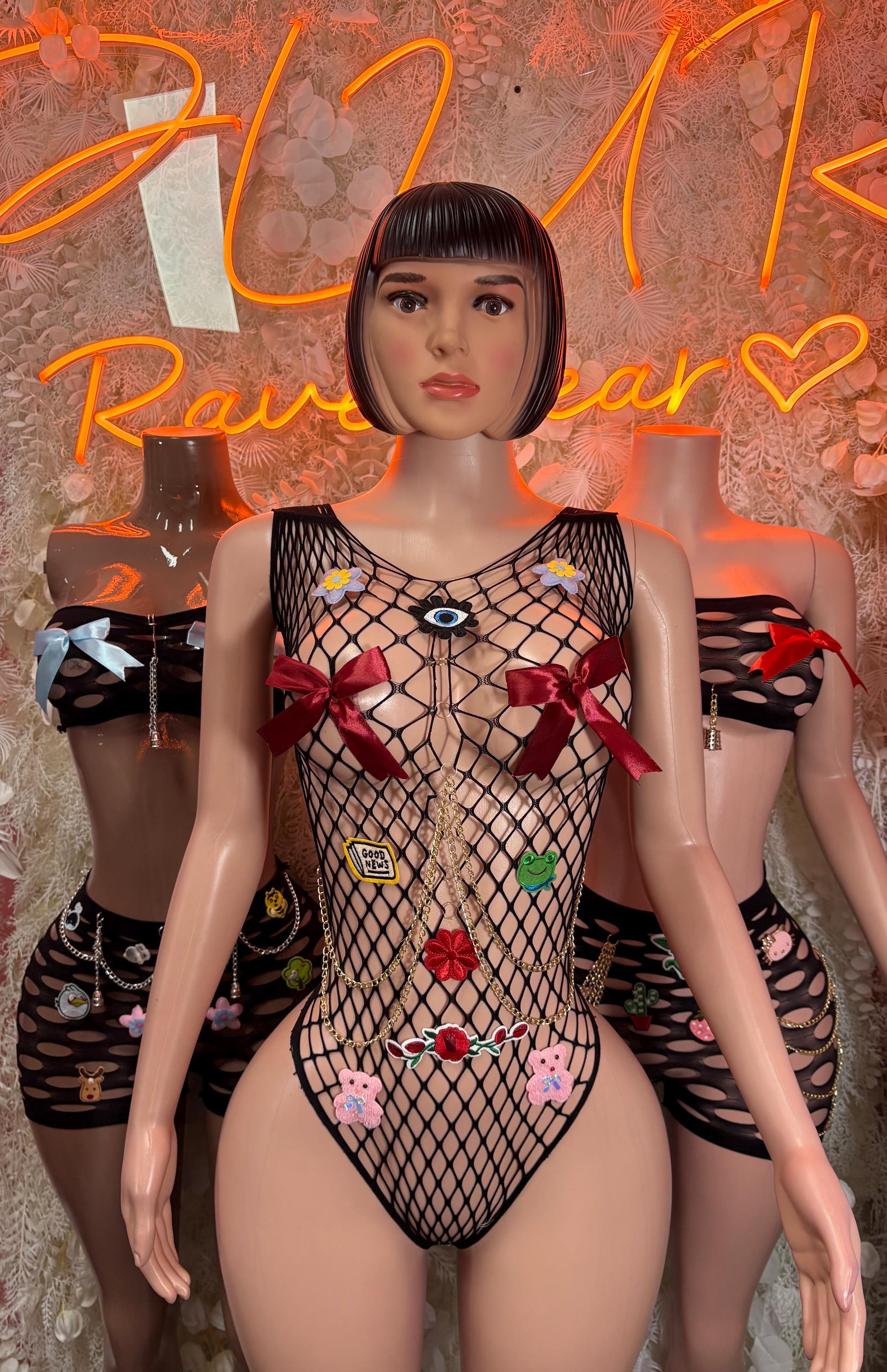 Black fishnet bodysuit with colorful flower appliques and red shoulder ties